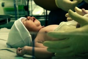 newborn infant on table